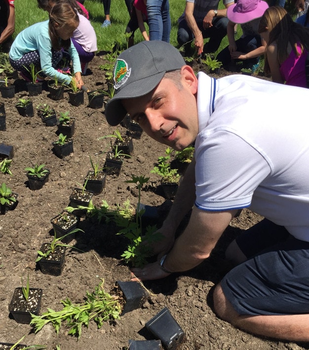 Stephen Holyday planting seedlings at a community event